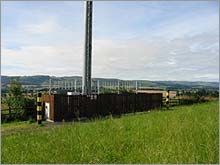 Monopole site with close boarded timber fence