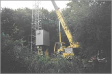 Specialist transport and lifting of equipment cabin at site with restricted access.